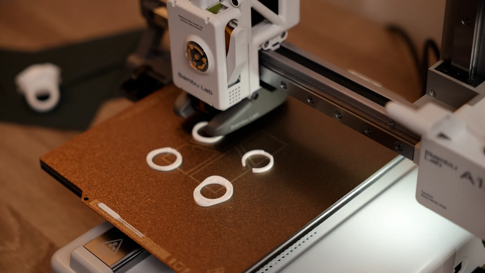 White rings printing on the build plate of a Bambu Lab printer.